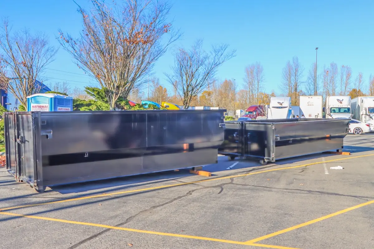 Professional dumpster rental service with roll-off container on residential driveway in Amelia